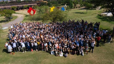 A large group of people standing in a field