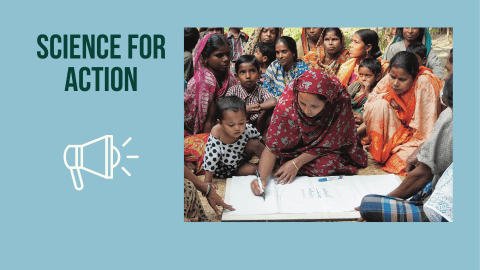 woman writing on a large piece of paper surrounded by people