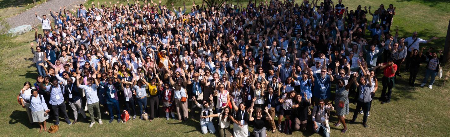 A large group of people standing in a field