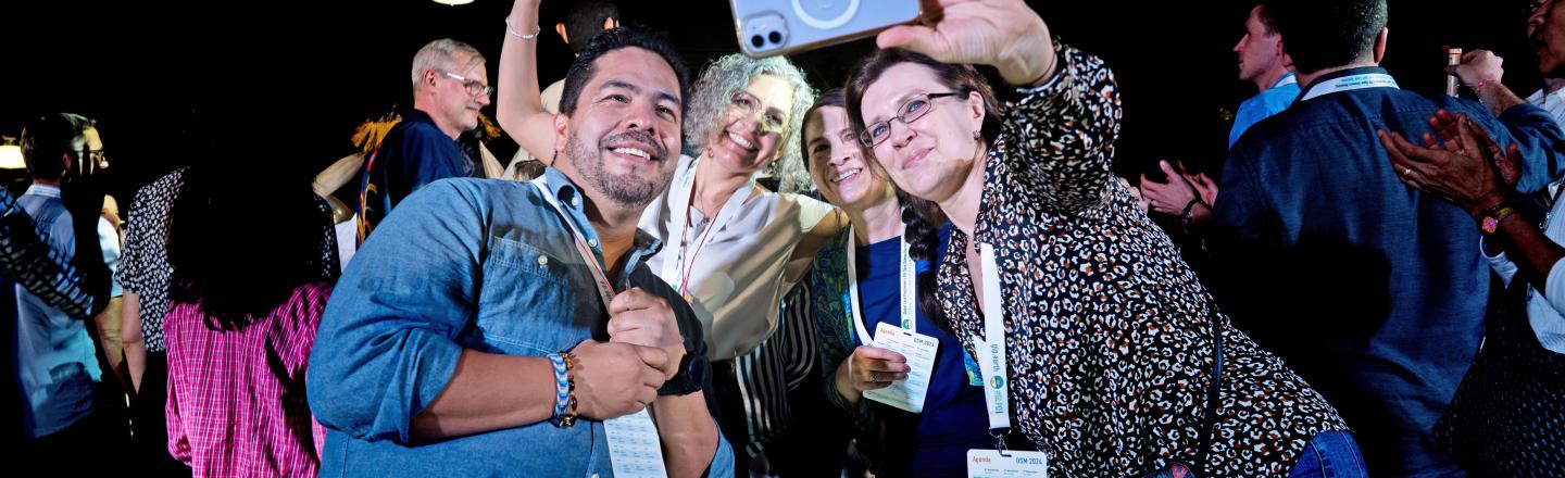Group of Open Science Meeting attendees taking a selfie, smiling