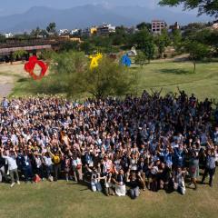 A large group of people standing in a field