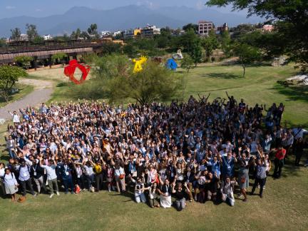 A large group of people standing in a field