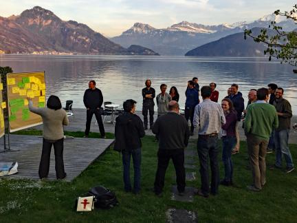 Group of people with presentation board in nature with mountains