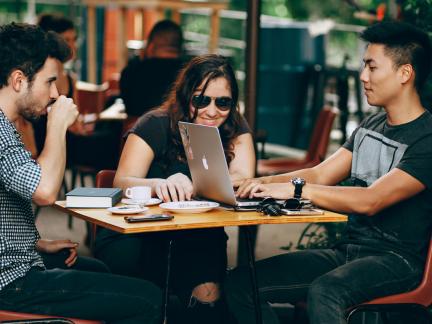 Young people having coffee and chatting while working